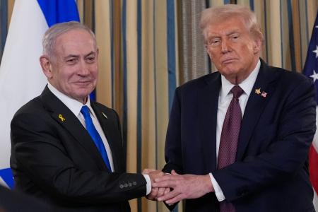 　２９日、共同記者発表後、握手を交わすイスラエルのネタニヤフ首相（左）とトランプ米大統領＝ワシントンのホワイトハウス（ＡＰ＝共同）