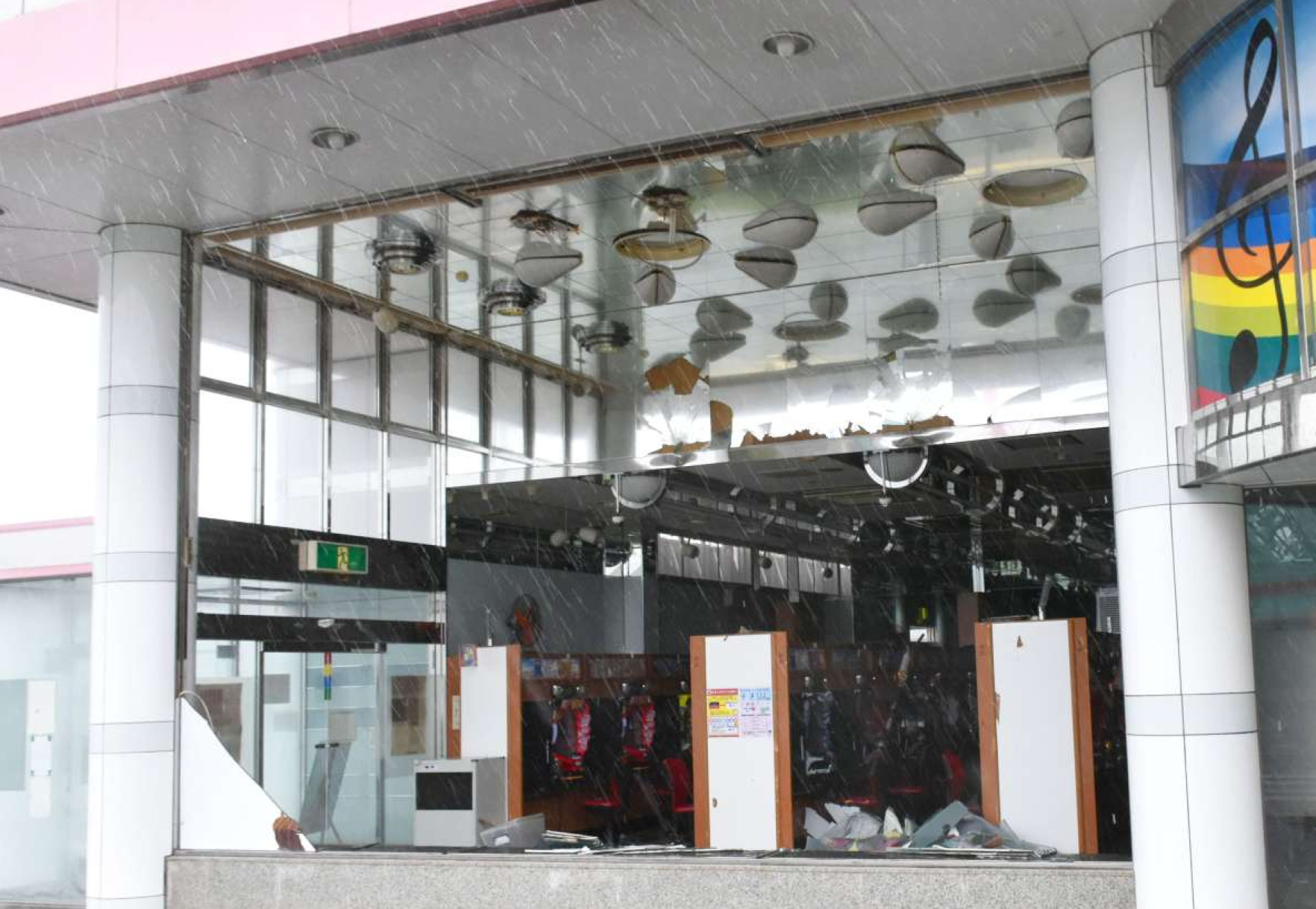 台風の影響で窓ガラスが割れ、パチンコ台がむき出しになったパチンコ店＝１８日午前１０時半ごろ、鹿屋市共栄町