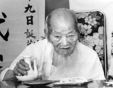 大還暦を迎え自宅で来客に焼酎をふるまう泉重千代翁（１９８５年６月２５日）