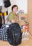 水に加え、非常用持ち出し袋などを備えている小原尚子さん＝７月１４日、熊本市東区