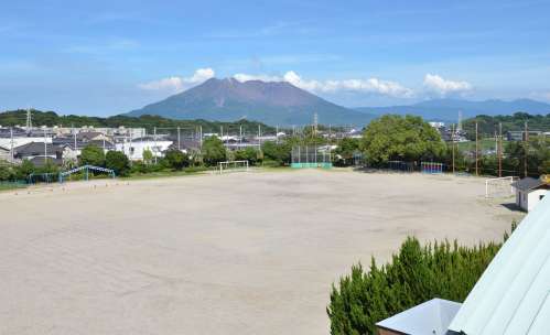 校舎から望む桜島の眺め。校庭は扇の形をしている＝鹿児島市の武岡小学校