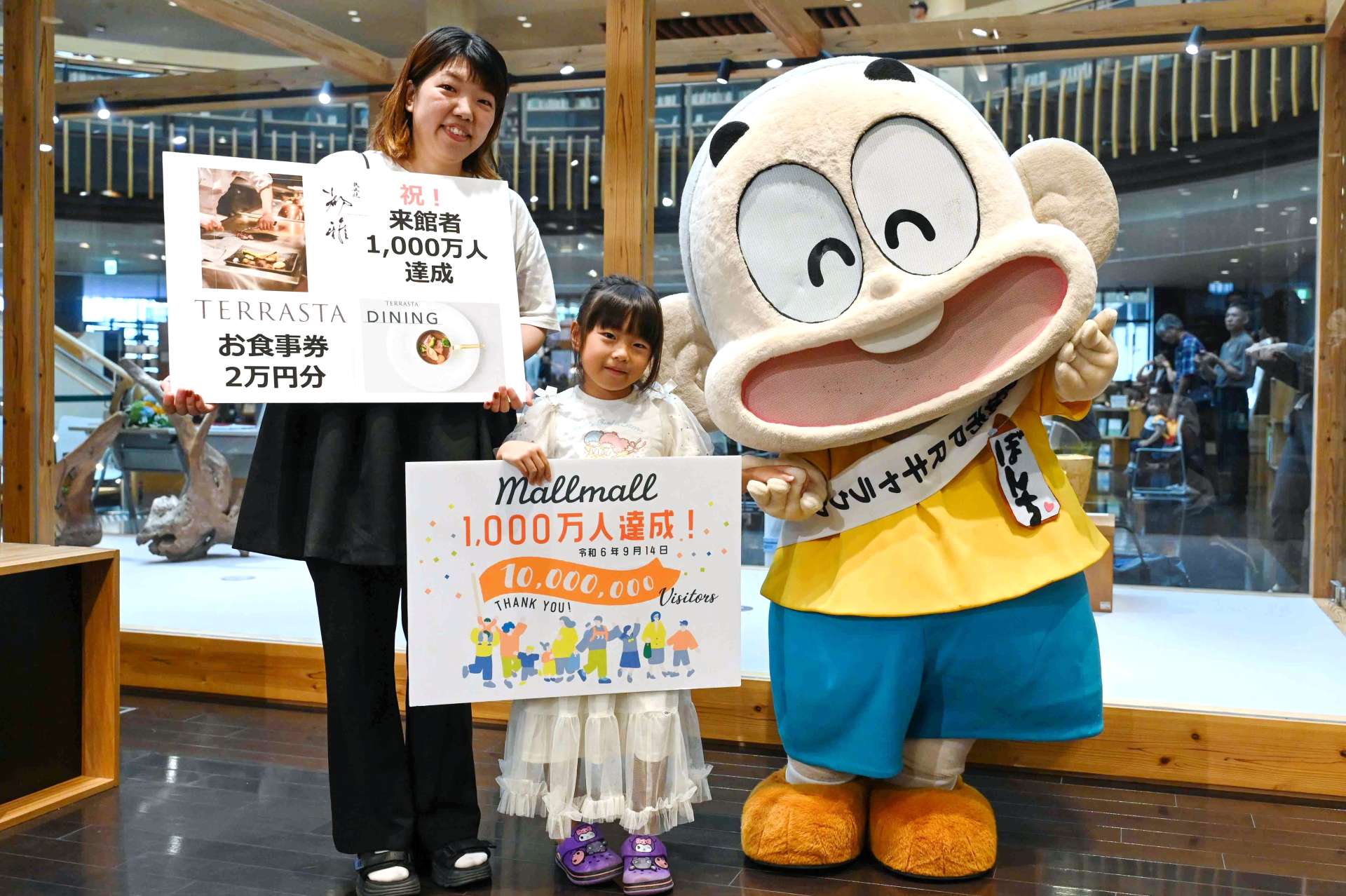 節目の１０００万人目となった金丸彩佳さん、心陽さん親子＝都城市立図書館