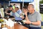 アボカドのベーコン巻きを試食する参加者＝出水市西出水町