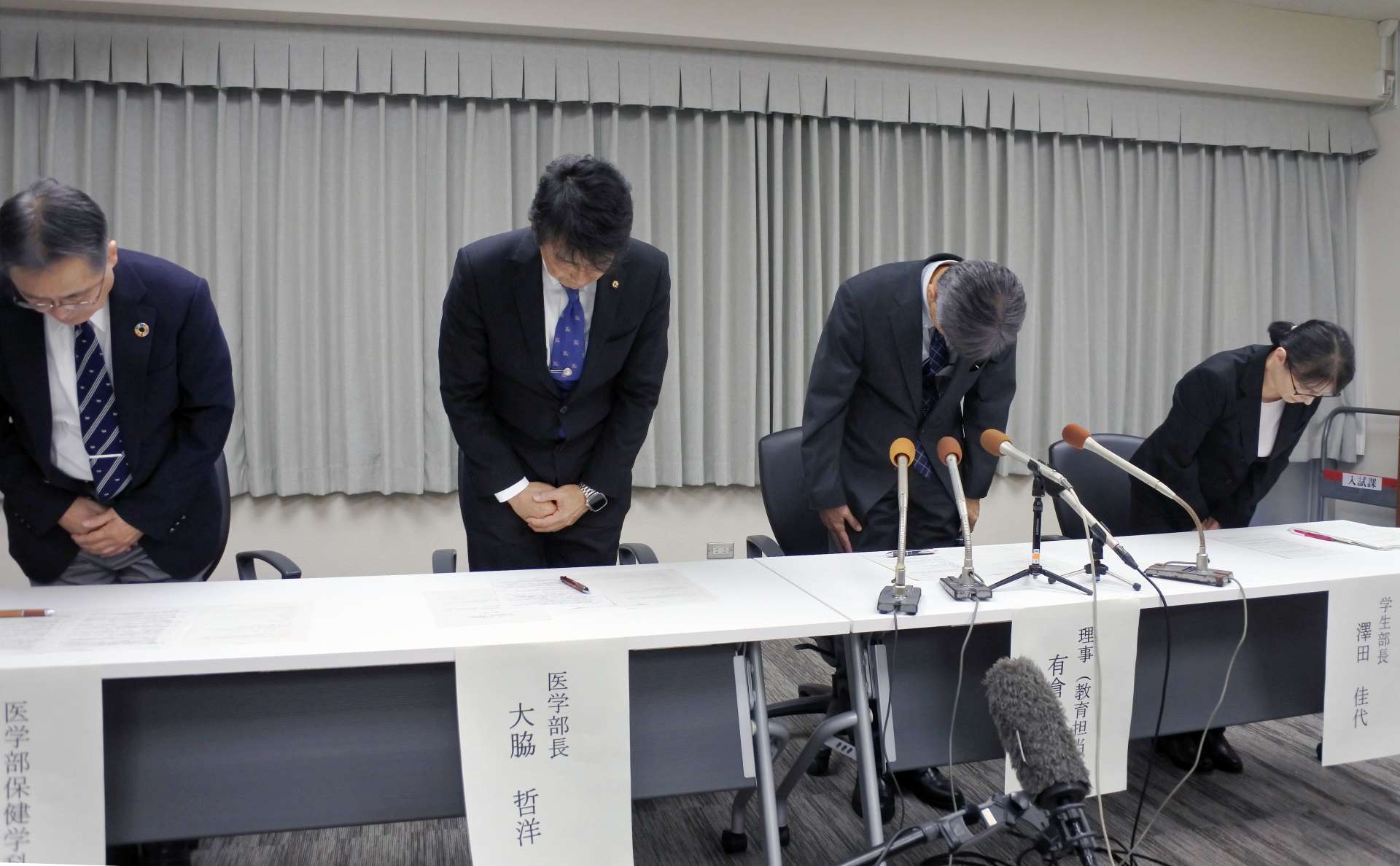 会見で謝罪する鹿児島大の有倉巳幸理事（右から２人目）ら＝５日、鹿児島市の鹿大郡元キャンパス
