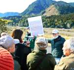 〈関連〉中岳（正面奥）を見ながら弾薬庫整備の経緯を聞く参加者＝２３日、さつま町永野