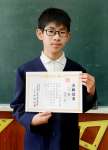 漢検２級合格証書を掲げる浦口航さん＝鹿児島市の黒神小学校