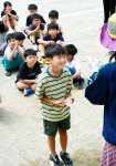 「合格許可証」のシールを受け取り笑顔の児童＝１０日、出水市の東出水小学校