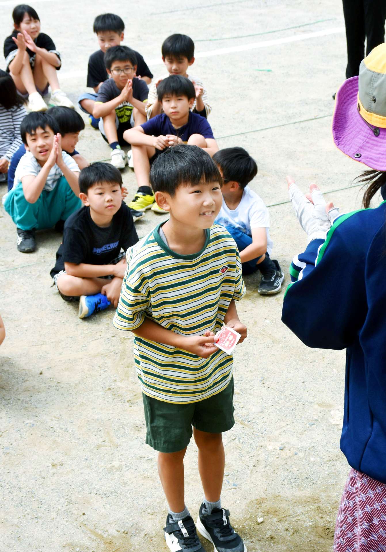 「合格許可証」のシールを受け取り笑顔の児童＝１０日、出水市の東出水小学校