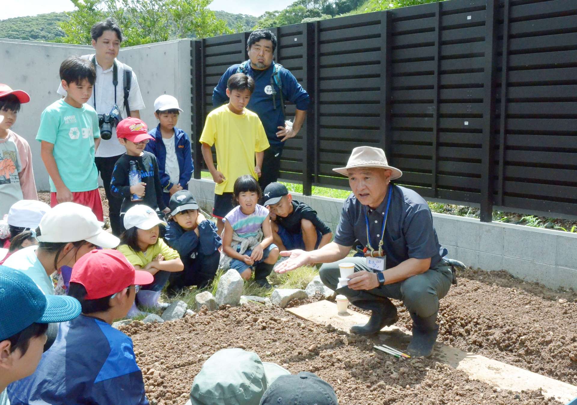 職員に種のまき方を教わる子どもたち＝２３日、大和村のアマミノクロウサギミュージアムＱｕｒｕＧｕｒｕ