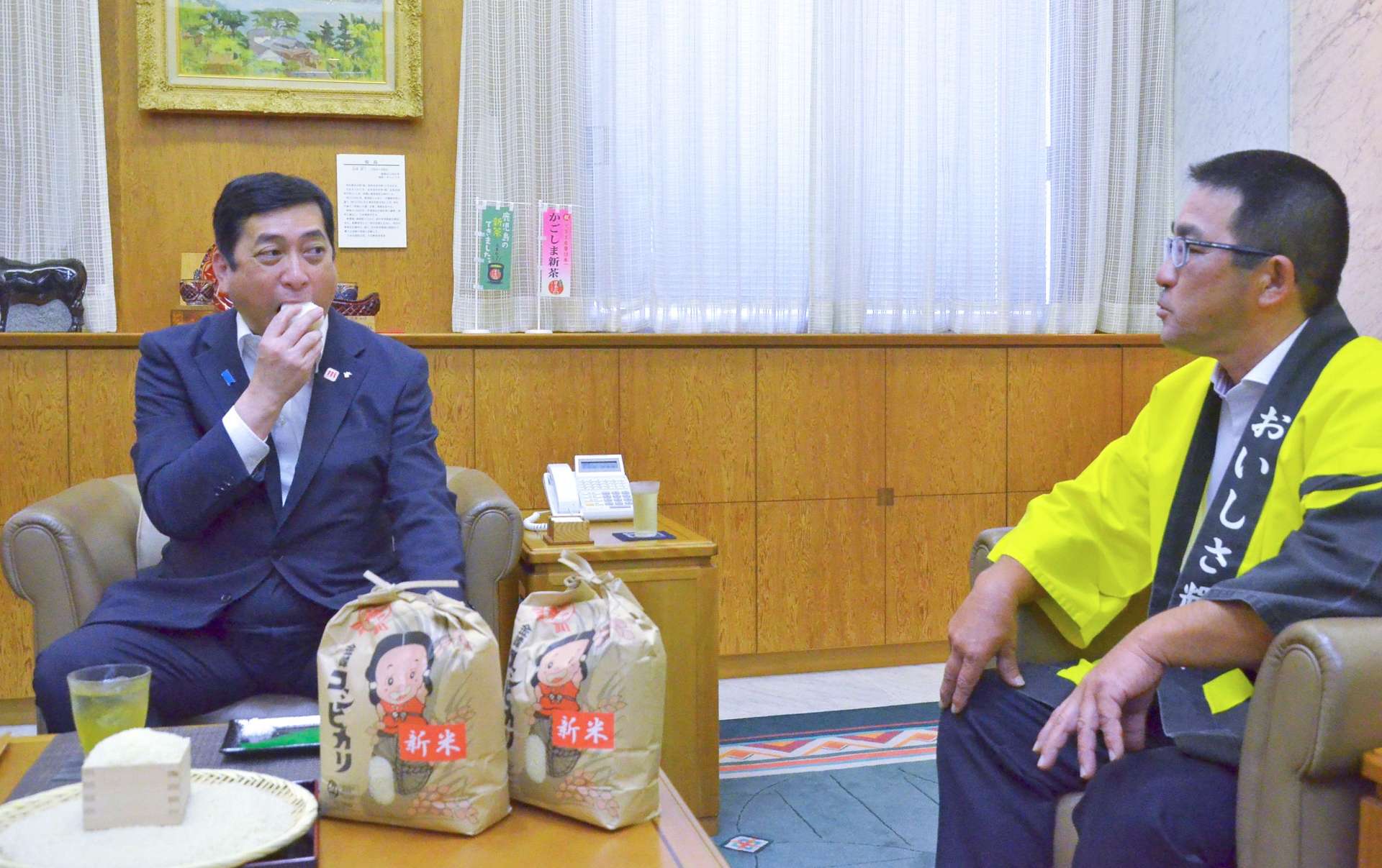 金峰コシヒカリの新米をＰＲするＪＡさつま日置金峰地区水稲部会の本町雄三部会長（右）＝１日、鹿児島県庁