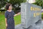 「都城空襲犠牲者追悼碑」の側面に新たに刻まれた犠牲者１３柱と刻字を提案した来住ケイ子さん＝都城市小松原町