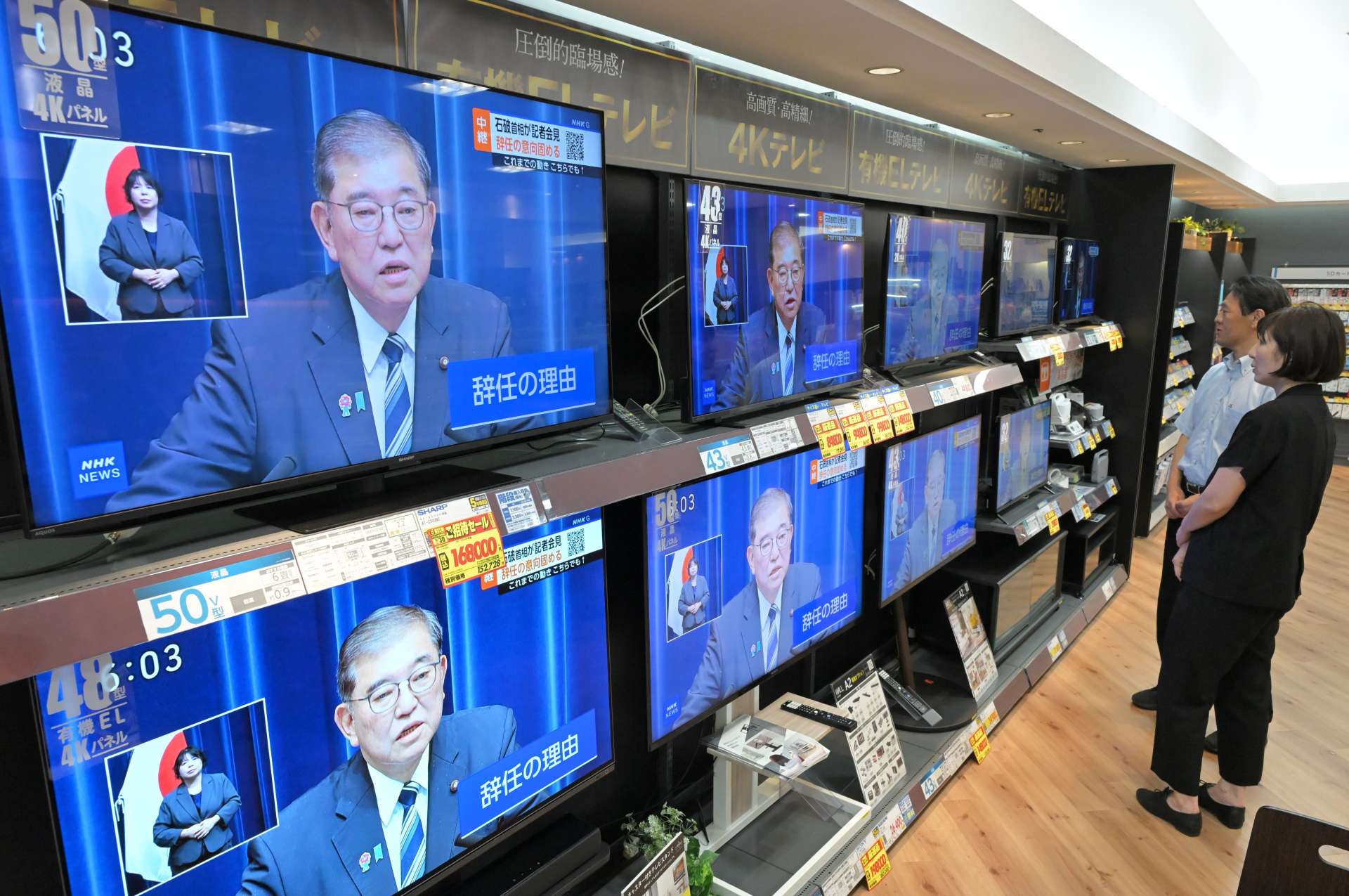 退陣する意向を表明した石破茂首相の記者会見を視聴する市民ら＝７日午後６時すぎ、鹿児島市のエディオン鹿児島山形屋店