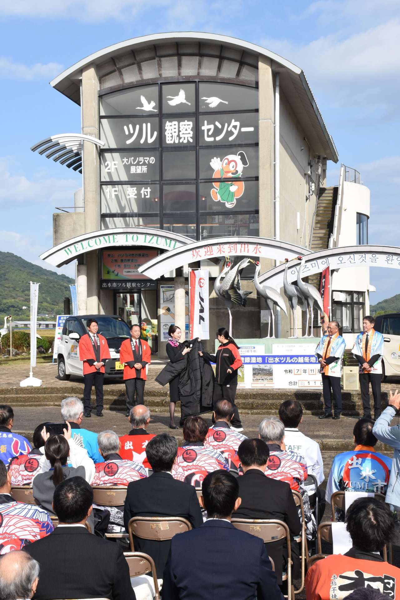 ツル観察センターのオープンを祝う関係者＝出水市荘