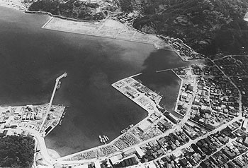 昭和４６年４月、埋め立てが進む名瀬港周辺。当時の紙面によると「市街地の過密化を解消するため、埋め立て事業を進めている旧名瀬市。完成すれば総面積７０ヘクタールとなり、現在の市街地面積約２１０ヘクタールの３分の１に当たる、ニュータウンが海縁に誕生する」と伝えている。