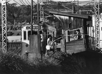 昭和６０年９月、市電の中でも最も古い木造の電停が残っていた岩崎谷電停。当時の紙面には写真グラフが組まれ、「９月に入り、沿線ではカメラ片手の市民が目立ち始めた。電車が走る風景には名残がつきない。数多い電停の中で最も古い姿を残していた岩崎谷電停は、昭和２３年に造られた」などと紹介している。