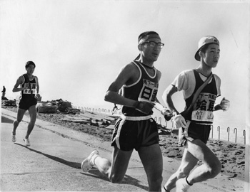 昭和４５年２月１９日、垂水市諏訪でトップに立つ姶良チームの曽山選手。紙面では「２区で姶良が巻き返して、以後姶良が終始トップを独走。初の日間優勝を飾るとともに大会初の総合優勝をなしとげた。（中略）４日間走ってトップ日置と２位姶良の差はわずか２秒。最終日は日置やや有利と思われたが、姶良があっさり予想をひっくり返した。（中略）“万年優勝候補”の汚名を返上し、念願の初優勝を果たした」などと報じていた。