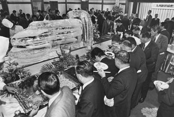 昭和６０年１月、着工準備作業所開設の祝賀会で据えられた１トン近い新幹線の氷彫刻。「九州新幹線の整備計画決定以来、実に１２年。背水の陣でのぞんだ陳情活動が見事、実を結び、約３００人の県政財界関係者で埋まった会場は祝賀ムード一色。彫刻を前に『もうすぐ本物もくるぞ』と喜びの声が上がった」と紙面は伝えている。