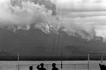 昭和３５年１月１９日、噴石で山火事を起こした桜島。紙面では「午後４時２３分の爆発では３５００メートルまで噴煙をあげ、火山弾をふくんだ赤熱噴石は引之平から古里付近の２合目あたりまで落下し、山火事を起こした。火山雷も数回記録され、鹿児島市内でも窓ガラスにひびくほどだった。爆発の規模からすると３０年１０月１３日の大爆発いらい５番目。噴石は４キロは飛んでいると推定されその距離からすると３０年の爆発につぐもの」と報じている。