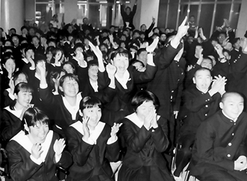 １００分間の死闘の終わりを告げる笛が鳴った瞬間、びしょぬれの選手たちはちょっとだけ残念そうな表情を見せた。だが、スタンドやテレビ桟敷からすぐに「ワーッ」と大きな拍手が上がる。待ちに待った鹿実全国制覇の実現だ。「ついに夢がかなった」「単独優勝の楽しみは次に」―。平成８年１月８日、国立競技場であった全国高校サッカー決勝は、鹿実が静岡学園に２点の先行を許しながら残り３分で追いつく、「両校優勝」にふさわしい名勝負。冬のあらしが列島を吹き荒れた午後、１０００キロ離れた東京と鹿児島を、熱い歓声が結んだ。鹿実の快挙に、地元鹿児島のテレビ桟敷からも「すごい」「よくやった」と称賛の声が送られた。